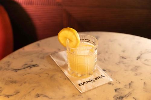 a drink with an orange slice on a table at Hotel Indigo Leeds by IHG in Leeds