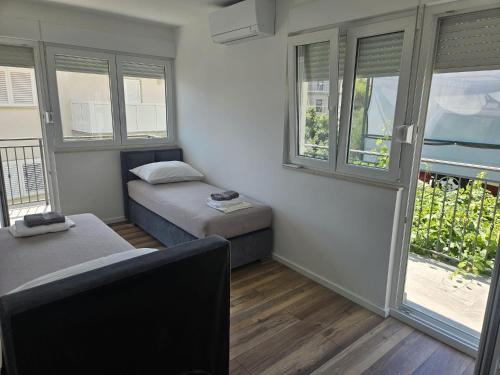 a small room with a bed and a window at Apartments with parking space Omis - 14422 in Omiš