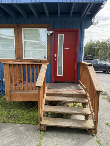 a front door of a house with a red door at Nightshade BnB in Anchorage