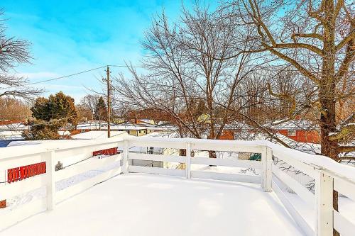 a white fence with snow on the ground at Entire 3 bed home in South Euclid w ac in South Euclid