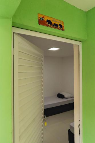 a door to a room with a bed in a room at Casa Ecotrips Barra Funda - Hostel in Sao Paulo