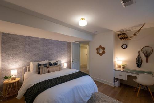 a bedroom with a large bed and a desk at Lake Effect Lodge 3 Minutes From Laketown Beach! in Holland