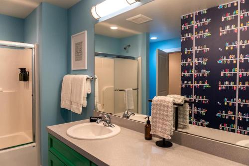 a bathroom with a sink and a shower at Lake Effect Lodge 3 Minutes From Laketown Beach! in Holland