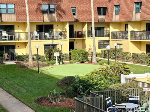 a golf course in front of a apartment building at Pier Pressure Beachfront Wpool in Cocoa Beach
