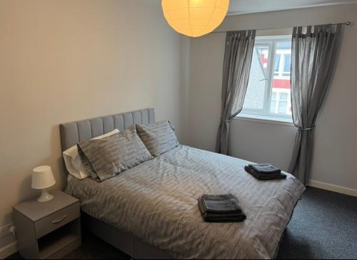 a bedroom with a bed with two towels on it at 118 NELSON STREET 1st FLOOR , LARGS in Largs