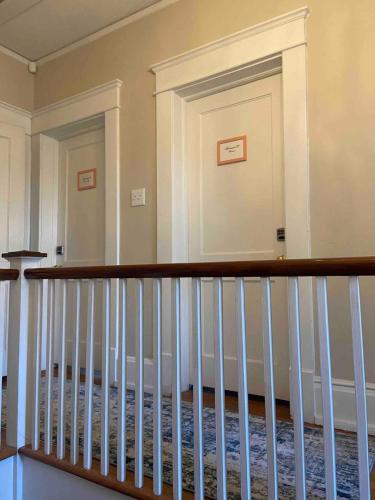 a staircase in a home with white railings at Efficiency In Grand Old Home, Downtown Durham in Durham