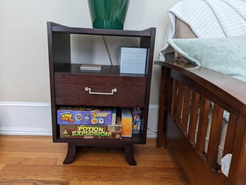 a nightstand with a drawer next to a bed at Efficiency In Grand Old Home, Downtown Durham in Durham