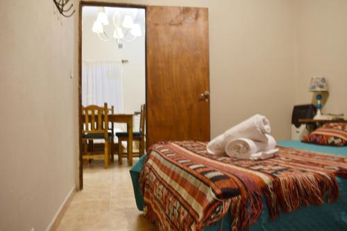 a bedroom with a bed with a towel on it at Hotel Cabañas Aparts Tierra de Glaciares in El Calafate
