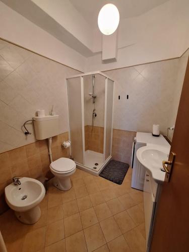 a bathroom with a shower and a toilet and a sink at Casa Conti Trivelli in Vasto