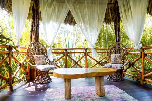 a living room with two chairs and a table at Muúnek Hotel Boutique Art & Spa, adults only in Barra Vieja