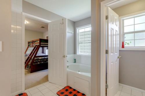 a bathroom with a bath tub and a sink at 4 Mi to Chattahoochee River Family Home with Yard! in Roswell