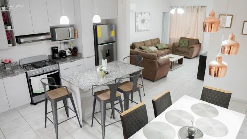 a kitchen and living room with a table and chairs at House in San Miguel, Res. San Andres in San Miguel