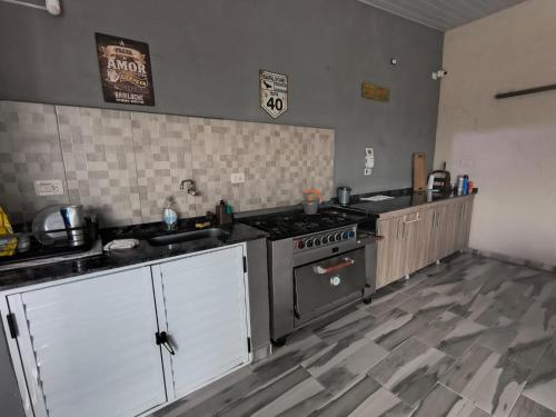 a kitchen with a stove and a counter top at Cabaña La Luisa DOS pileta quincho salon in Formosa
