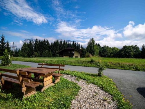 a picnic table and bench on the side of a road at Villa with terrace, sauna near the border triangle in Arnoldstein