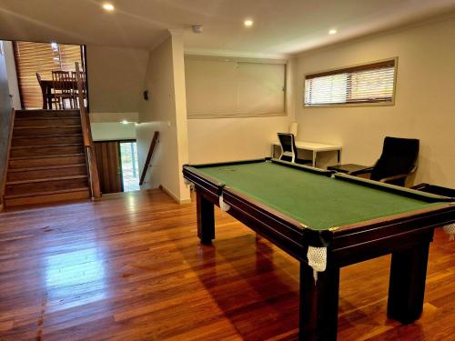 a living room with a pool table in it at Seas The Day - Free Wifi, 180m Walk TO THE Beach in Vincentia