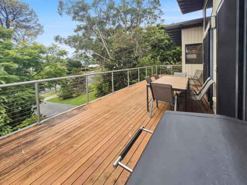a wooden deck with a table and chairs on a house at Seas The Day - Free Wifi, 180m Walk TO THE Beach in Vincentia