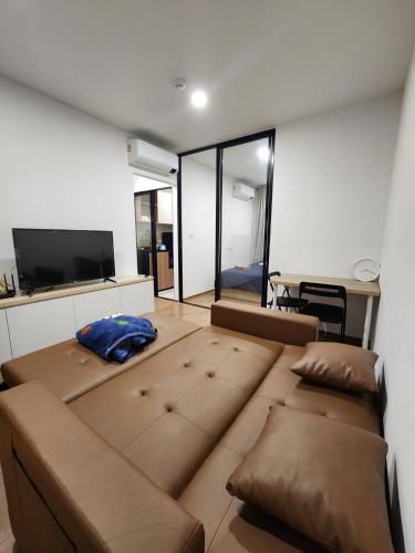 a living room with a large couch and a tv at Cozy Downtown Apartment - long stay in Bangkok- MRT Phasi charoen in Bangkok