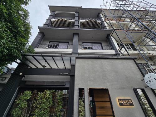 a building with balconies on the side of it at Sukhum Rajamangala-Phatthanakan Rooms in Bangkok