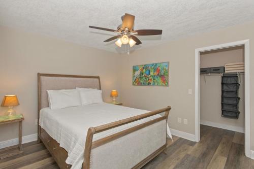 a bedroom with a bed and a ceiling fan at Coconut Breezes near Anna Maria Island in Bradenton