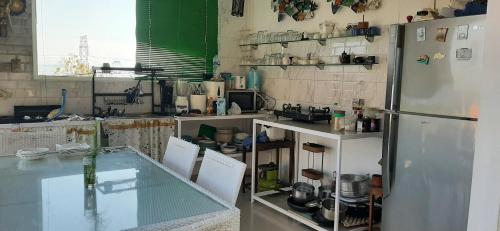 a kitchen with a glass counter and a refrigerator at Cantik Villa in Lovina