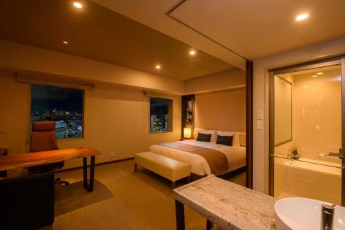 a hotel room with a bed and a bathroom at Tokyu Stay Ginza in Tokyo