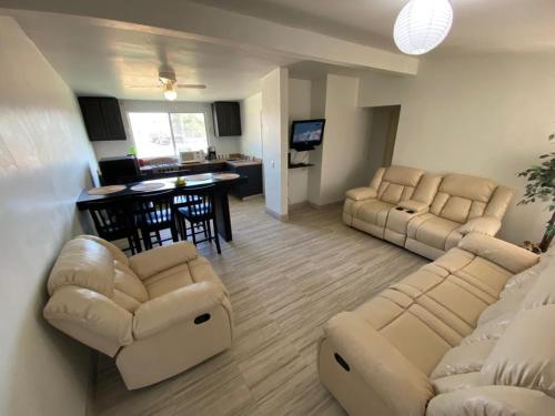 a living room with two couches and a dining room at Family Apartment & Free Parking! in Rosarito Beach