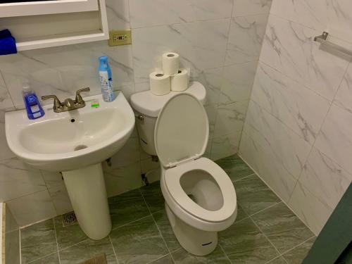 a bathroom with a toilet and a sink at Pedro's Heights 2 Bed, 1 Bath in Tumon