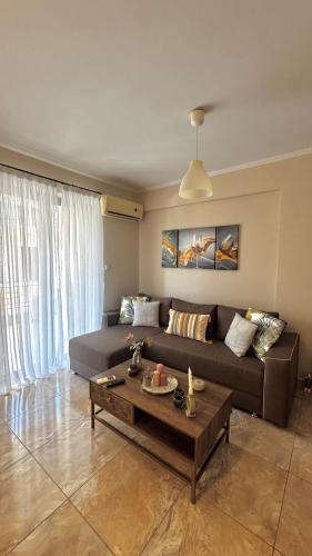 a living room with a couch and a coffee table at Anesis home in Gythio