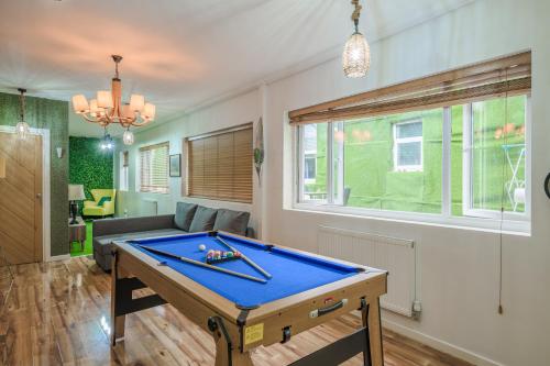 a living room with a ping pong table in it at CityCentreApartments in Birmingham
