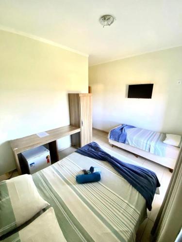 a bedroom with two beds in a room at Hotel Rezende in Villa Nova de Resende