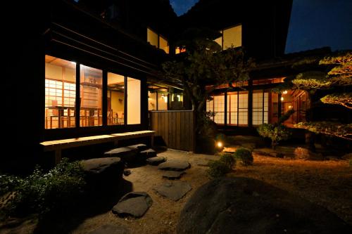 a house at night with a pathway in front of it at 島宿栞 in Tonosho