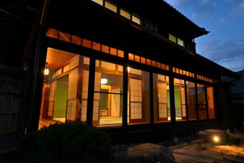 a house with large windows on the side of it at 島宿栞 in Tonosho