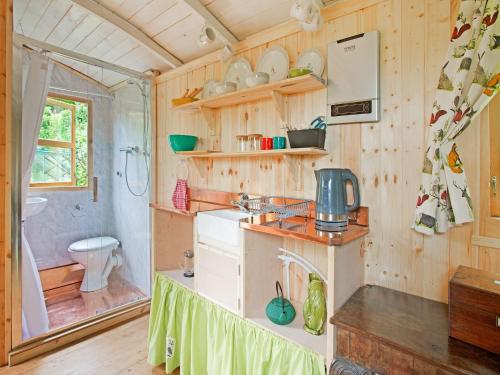 a small kitchen with a sink and a toilet at Shepherds Hut near Exmoor National Park in Taunton