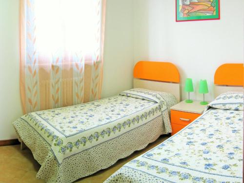 two twin beds in a room with a window at Holiday Home Bardolino with Pool near Lake in Bardolino