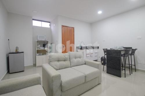 a living room with a couch and a table at Comfortable 1 Br In The Center Of Ciudad Del Este in Ciudad del Este