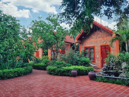a brick house with a brick walkway in front of it at Trang An Village Homestay in Ninh Binh