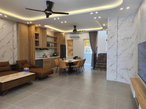 a living room with a couch and a table at Villa ATH Nova Word Phan Thiết in Bình Tú