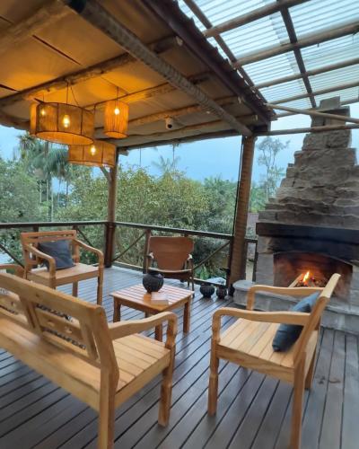 a deck with benches and a fireplace at Casa da Pedra Serrinha in Resende