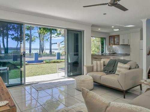 a living room with a couch and a table at Welcome to Bay Views on Esplanade in Tin Can Bay