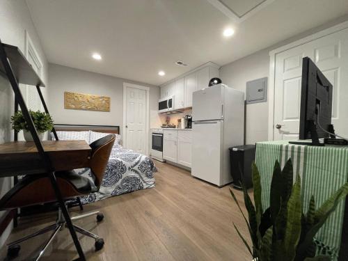 a kitchen with a desk and a kitchen with a refrigerator at Brand New Guest Suite + Full Kitchen + Parking in San Jose