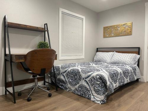 a bedroom with a bed and a desk and a chair at Brand New Guest Suite + Full Kitchen + Parking in San Jose