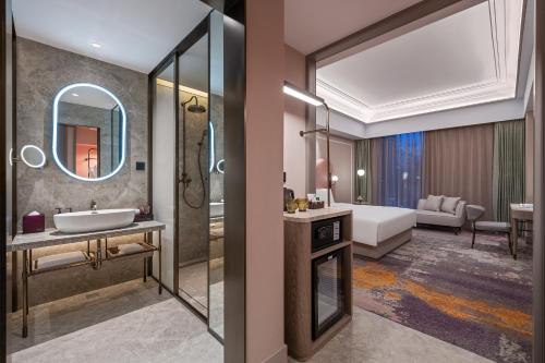 a bathroom with a sink and a mirror at Mercure Beijing Downtown in Beijing