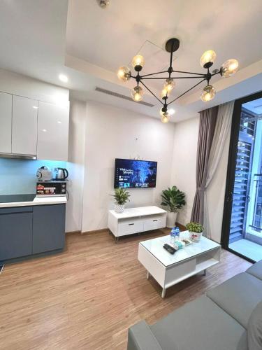 a living room with a table and a kitchen at Great 2bedroom Apt Quick To My Dinh And Marriott Hotel, 30 Minutes To Airport in Hanoi
