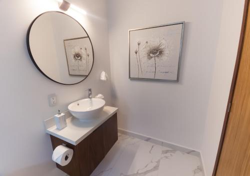 a bathroom with a sink and a mirror at Modern 2BR Ocean view - Walk to Beach and Downtown in Puerto Vallarta