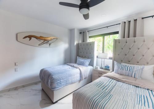 a bedroom with two beds and a window at Modern 2BR Ocean view - Walk to Beach and Downtown in Puerto Vallarta