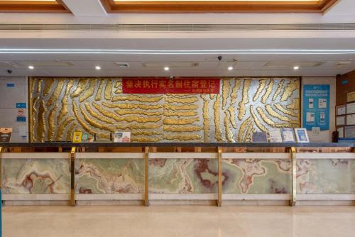 a wall in a building with a painting at Billions-Earn Hotel (near Guangdong Foshan Creative Park and China Ceramics City) in Foshan