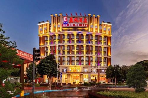 a large building with lights on the side of it at Billions-Earn Hotel (near Guangdong Foshan Creative Park and China Ceramics City) in Foshan