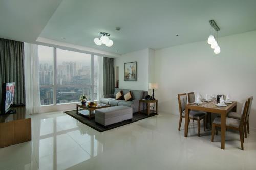 a living room with a couch and a table at Calidas Landmark 72 Royal Residence Hanoi in Hanoi