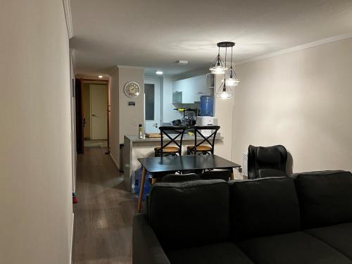 a living room with a couch and a kitchen at Brisas de Puyai apartment for 5 people in Lilén