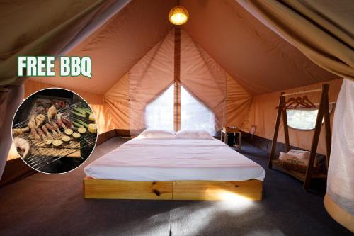 a bed in a tent with a fire brook sign at Sendoro Retreat in Láng Lớn